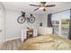 Well-lit bedroom with a large window, ceiling fan, and a modern desk area at 11063 Running Ridge Rd, Charlotte, NC 28226