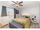 Bright bedroom boasts a ceiling fan, large window, and a neutral color scheme at 11063 Running Ridge Rd, Charlotte, NC 28226