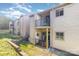 Townhouse exterior with balconies, beige siding, well-kept lawn, and partial brick features at 11063 Running Ridge Rd, Charlotte, NC 28226