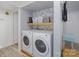 Well-lit laundry room features a washer and dryer, shelf, and storage baskets at 11063 Running Ridge Rd, Charlotte, NC 28226