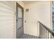 Apartment porch with gray door, doorbell, and light at 11063 Running Ridge Rd, Charlotte, NC 28226
