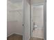 Hallway view to a toilet and tiled floor bathroom. To the left is a closet at 11929 Kings Castle Ct, Charlotte, NC 28277