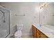 Bright bathroom featuring a shower, toilet, vanity, and ample lighting at 11929 Kings Castle Ct, Charlotte, NC 28277