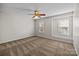 Bedroom with neutral walls, carpet, a ceiling fan, and windows providing natural light at 11929 Kings Castle Ct, Charlotte, NC 28277