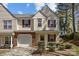 Charming two-story townhome with red shutters, a one car garage, and well-maintained landscaping at 11929 Kings Castle Ct, Charlotte, NC 28277