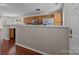 Kitchen with stainless steel appliances and wood cabinets and a view into the living room at 11929 Kings Castle Ct, Charlotte, NC 28277