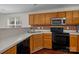 Kitchen featuring wood cabinets, sleek appliances, and a tiled backsplash at 11929 Kings Castle Ct, Charlotte, NC 28277