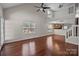 Open-concept living room with hardwood floors, large windows, and a view of the kitchen at 11929 Kings Castle Ct, Charlotte, NC 28277