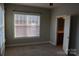 Bright bedroom with large window, neutral paint, and en-suite bathroom at 121 Irving Ave # A, Mooresville, NC 28117