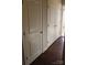 Hallway with wood floors and multiple white paneled doors at 121 Irving Ave # A, Mooresville, NC 28117