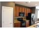 Stylish kitchen showcasing dark appliances, granite countertops, and rich wood cabinetry at 121 Irving Ave # A, Mooresville, NC 28117