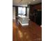 Well-equipped kitchen with center island, stainless steel refrigerator, and open layout to living area at 121 Irving Ave # A, Mooresville, NC 28117