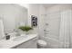 Clean bathroom with a single vanity, framed mirror, and shower/tub combo at 124 N Shayna Rd, Troutman, NC 28166