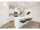 Bright kitchen features white cabinets, stone backsplash, stainless appliances, and a large center island at 124 N Shayna Rd, Troutman, NC 28166