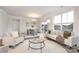 Bright living room features a sofa, chairs, round rug, and large windows at 124 N Shayna Rd, Troutman, NC 28166