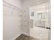 Walk-in closet with wire shelving and view of primary bathroom at 124 N Shayna Rd, Troutman, NC 28166