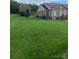 This backyard offers a beautifully landscaped lawn with an attractive brick house on the side at 139 Sain Rd, Statesville, NC 28625