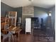 Cluttered living room featuring brick fireplace, door, and window at 143 Harvest Dr, Kings Mountain, NC 28086