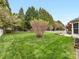 Expansive backyard featuring well-manicured lawn, white picket fence, and lush landscaping at 14923 Colonial Park Dr, Huntersville, NC 28078