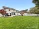 Spacious backyard featuring a well-kept lawn, patio area, and white picket fence at 14923 Colonial Park Dr, Huntersville, NC 28078