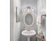 Stylish bathroom features a pedestal sink, decorative mirror and contemporary lighting at 14923 Colonial Park Dr, Huntersville, NC 28078
