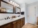 Bathroom features a dual sink vanity with granite countertops and modern fixtures at 14923 Colonial Park Dr, Huntersville, NC 28078