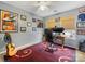Home office space featuring gray walls, a ceiling fan, framed pictures and posters, and a window letting in natural light at 14923 Colonial Park Dr, Huntersville, NC 28078
