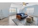 Bright and spacious bonus room featuring a blue area rug, hardwood flooring, and plenty of windows at 14923 Colonial Park Dr, Huntersville, NC 28078
