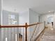 Upstairs hallway features hardwood floors, natural light, and a view of the foyer at 14923 Colonial Park Dr, Huntersville, NC 28078