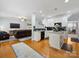 Open-concept kitchen featuring white cabinets, hardwood floors, and an island at 14923 Colonial Park Dr, Huntersville, NC 28078