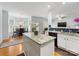 Bright, open kitchen with granite counters, white cabinets, and hardwood floors at 14923 Colonial Park Dr, Huntersville, NC 28078