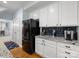 Well-equipped kitchen features white cabinets, granite countertops, and stainless steel appliances at 14923 Colonial Park Dr, Huntersville, NC 28078