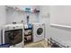 Spacious laundry room is equipped with a washer, dryer, and shelving for storage at 14923 Colonial Park Dr, Huntersville, NC 28078