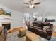 Bright living room featuring a fireplace, hardwood floors, and an open layout at 14923 Colonial Park Dr, Huntersville, NC 28078