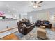 Comfortable living room features two leather sofas, wood floors and a ceiling fan at 14923 Colonial Park Dr, Huntersville, NC 28078