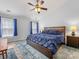 Comfortable bedroom features a ceiling fan, and natural light from the windows at 14923 Colonial Park Dr, Huntersville, NC 28078