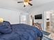 Comfortable bedroom features a ceiling fan, and natural light from the windows at 14923 Colonial Park Dr, Huntersville, NC 28078