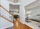 View of staircase and entryway into another room featuring hardwood floors and gray walls at 14923 Colonial Park Dr, Huntersville, NC 28078