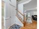 View of hardwood floors, staircase with wood railing, and entry to a living space at 14923 Colonial Park Dr, Huntersville, NC 28078