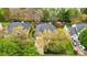 An aerial view showing a home's backyard, mature trees, landscaping, driveway and neighborhood at 1509 Burning Lantern Ln, Kannapolis, NC 28081