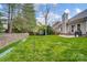A spacious backyard featuring a well-maintained lawn and mature trees at 1509 Burning Lantern Ln, Kannapolis, NC 28081