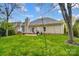 The backyard features a patio, grill, string lights and manicured lawn at 1509 Burning Lantern Ln, Kannapolis, NC 28081