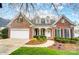Charming brick home featuring manicured landscaping, inviting entryway, and two-car garage at 1509 Burning Lantern Ln, Kannapolis, NC 28081