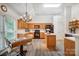 Bright kitchen with wooden cabinets, skylight, black appliances, and a cozy breakfast table at 1509 Burning Lantern Ln, Kannapolis, NC 28081