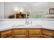 Open kitchen with an undermount sink, light countertops, and a view of the living area at 1509 Burning Lantern Ln, Kannapolis, NC 28081