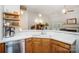 Open kitchen features an undermount sink and stainless steel dishwasher, with a view of the living area at 1509 Burning Lantern Ln, Kannapolis, NC 28081