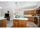 Well-lit kitchen featuring wooden cabinets, island, stainless steel appliances and breakfast area at 1509 Burning Lantern Ln, Kannapolis, NC 28081