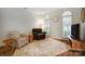 Comfortable living room with plush seating, two windows, and a media cabinet at 1509 Burning Lantern Ln, Kannapolis, NC 28081