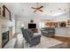Open living room with fireplace, ceiling fan, hardwood floors, connecting to kitchen area at 1509 Burning Lantern Ln, Kannapolis, NC 28081
