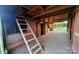 Barn interior with wooden beams, stalls, and ladder, offering a rustic yet functional space at 1524 J Rhyne Reep Rd, Vale, NC 28168